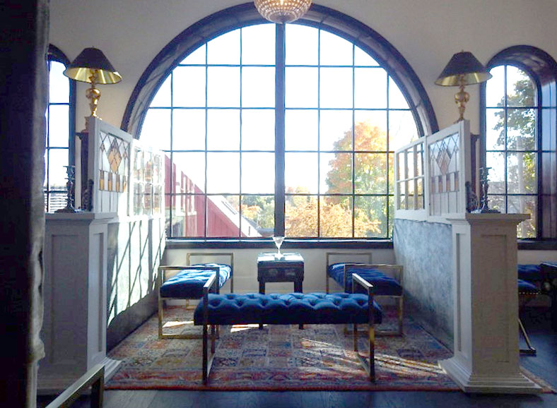 Comfortable seating area in front of a large window at the Elora Mill Hotel and Spa