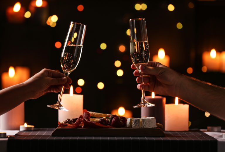 Two hands toasting with champagne flutes